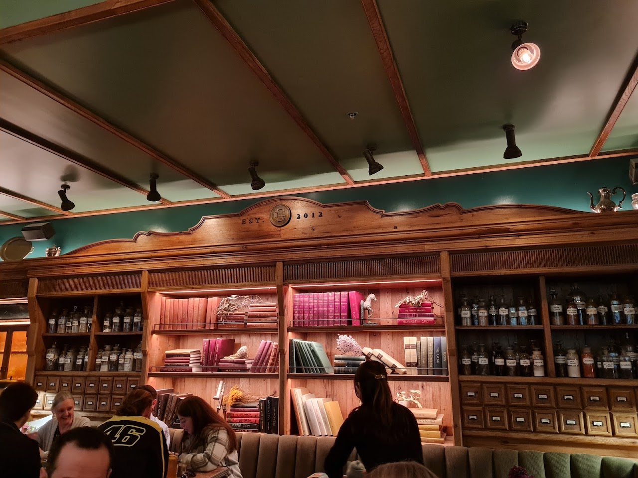 Shelves, bottles and books in the dining room